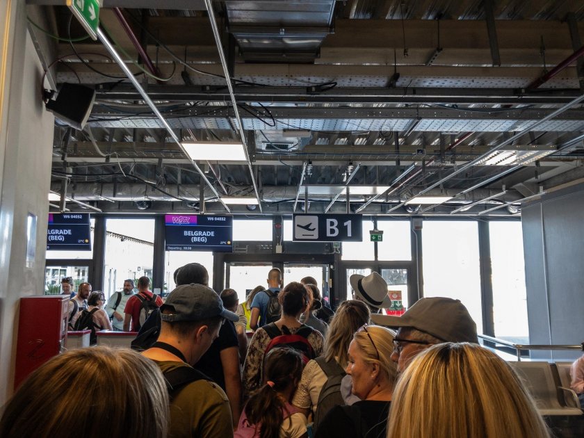 A line of passengers at the boarding gate at the airport