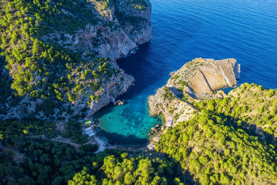 The turquoise cove of Cala es Porticol with its sheer cliffs, Ibiza