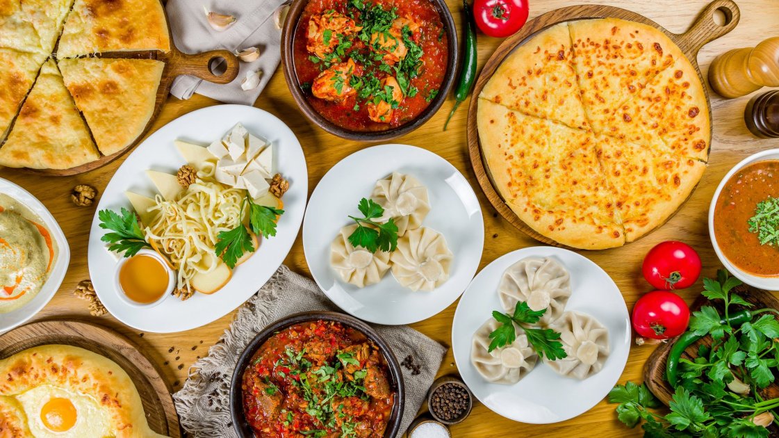 A Georgian feast featuring traditional dishes and wine