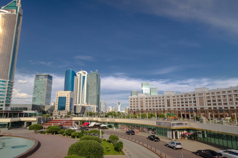 New business district timelapse hyperlapse with traffic on road and music fountain from bridge in the capital of Kazakhstan in Nur-Sultan city
