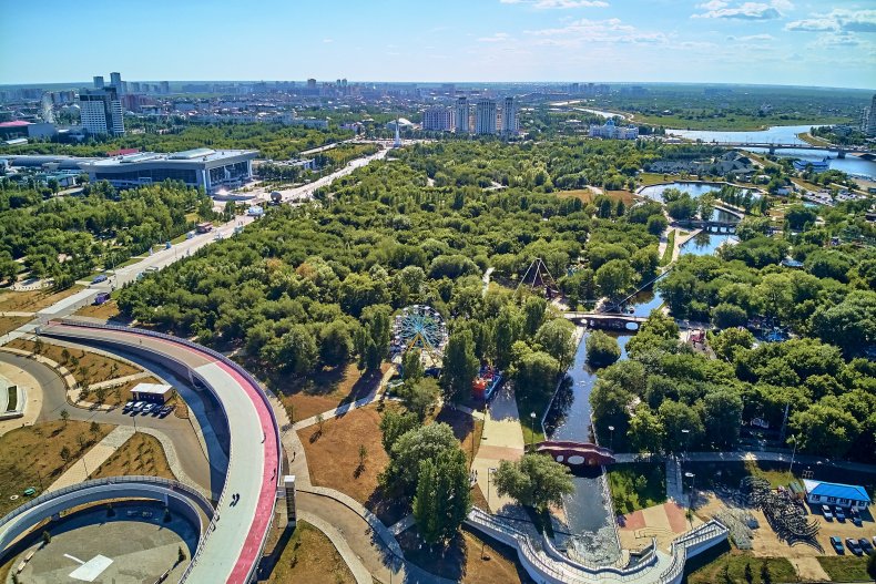 Красивый панорамный вид с воздуха с беспилотника на набережную реки Ишим ??? Центр города Нур-Султан или Нурсултан (Астана) с небоскребами и современным пешеходным мостом 