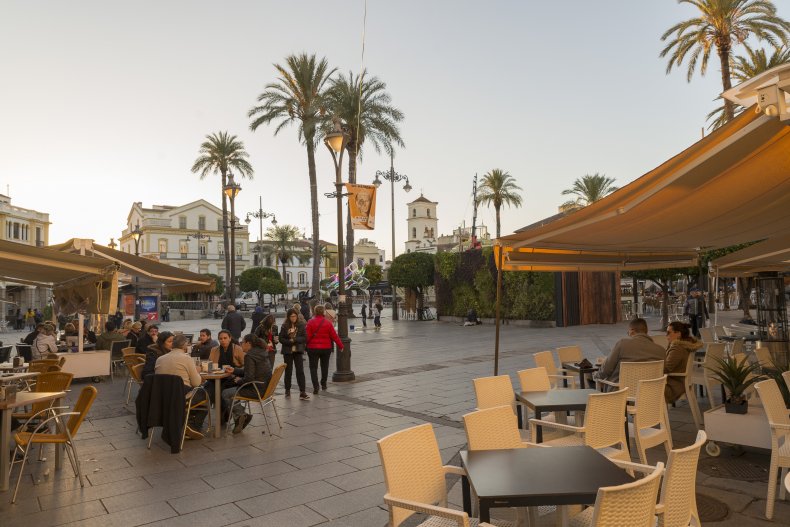 MERIDA, BADAHOS, SPAIN - NOVEMBER 23, 2018: terraces in the main square as darkness falls 