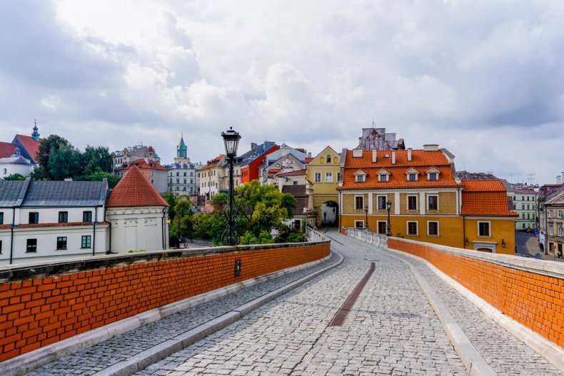 A cobblestone street and bridge leading to the city gates and the historic center of Lublin