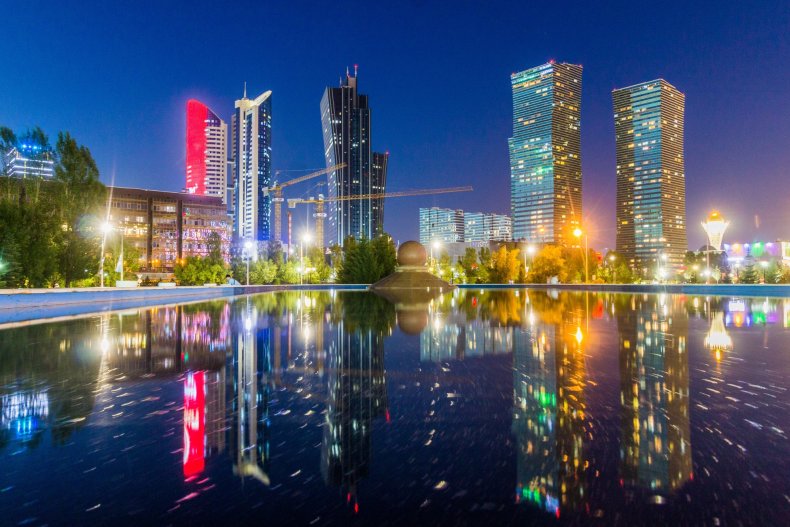 Astana at night—skyscrapers reflected in the water