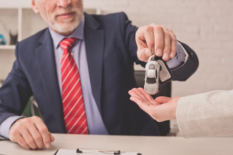 El agente entrega las llaves del coche al cliente